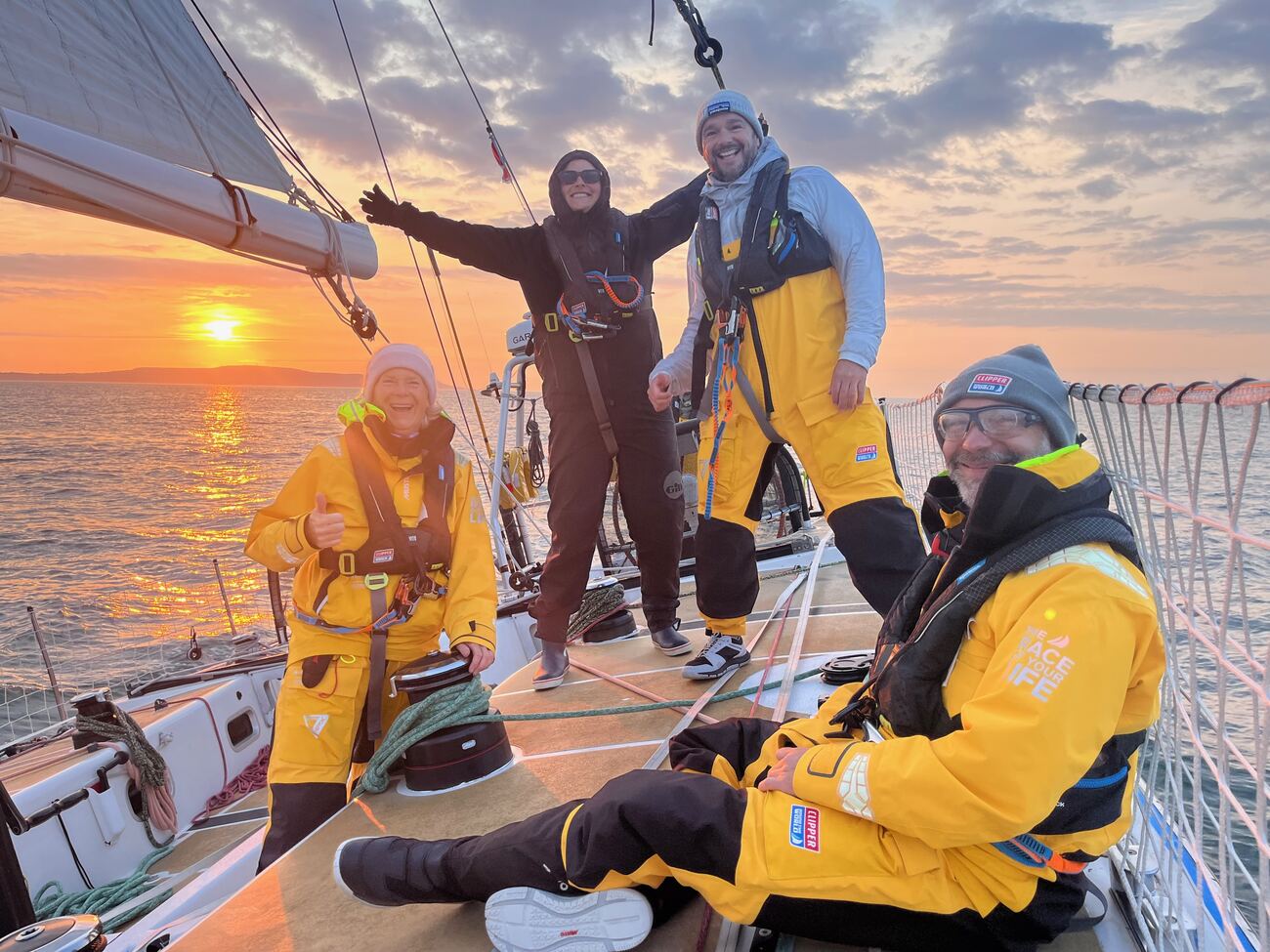 Three crew on deck at dawn